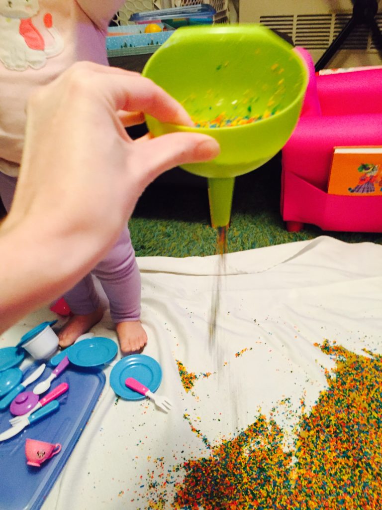 Pouring rice through a funnel, 12 Colored rice activities, 12 colored rice play ideas, sensory activity, activities for one year olds, montessori activities for a toddler, activities for 13 month old, activities for 14 month old, activities for 15 month old, activities for 16 month old, activities for 17 month old, activities for 18 month old, activities for a toddler, activities for one year olds, activities for two year olds activities