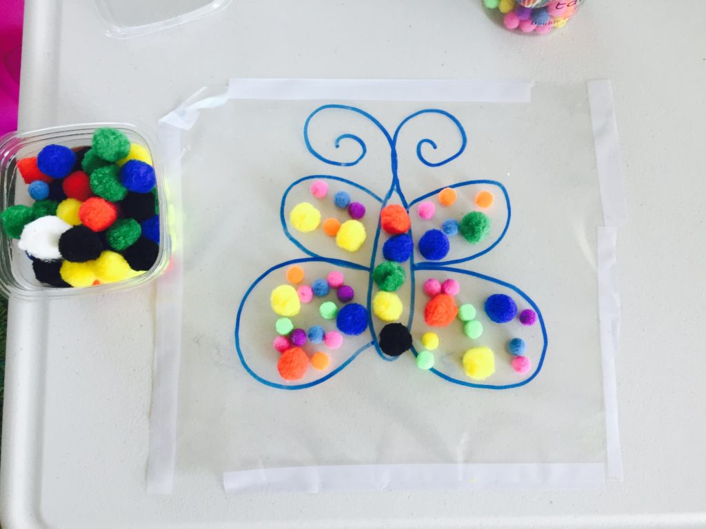 Decorate butterfly with pompoms, activities for 1.5 year old, activities for two year old, activities for toddlers, toddler crafts, creative activities for toddlers, activities for 18 month old, activities for 19 month old, activities for 20 month old, activities for 21 month old, activities for 22 month old, activities for 23 month old, activities for 24 month old