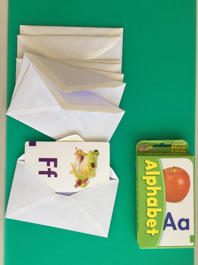 Wednesday box of activities, taking flashcards out of envelopes, activities for 14 month olds, activities for 15 month olds, activities for 16 month olds, activities for 17 month olds, activities for 18 month olds, activities for toddlers, activities for 19 month olds, activities for 20 month olds