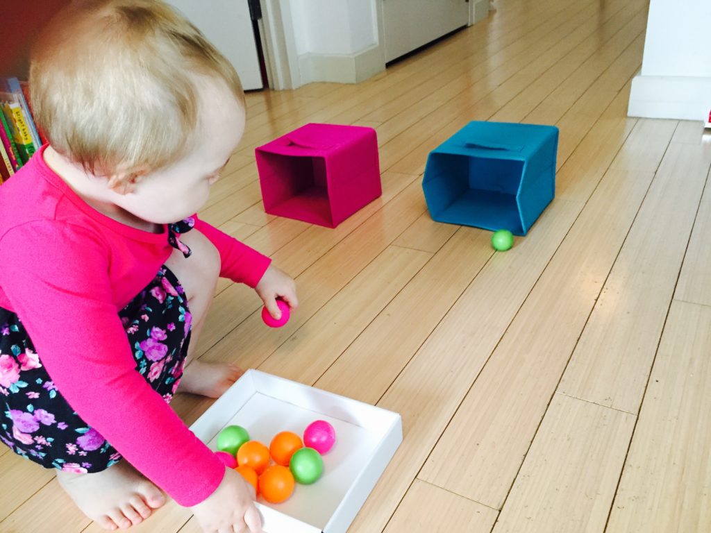 Rolling ping pong balls into boxes, toddler activities, activities for one year old, activities for two year old, fun activities for toddlers, indoor activities for toddlers, rainy day toddler activities, activities for 20 month old, things to do with toddler, educational activities for toddlers, learning activities for toddlers