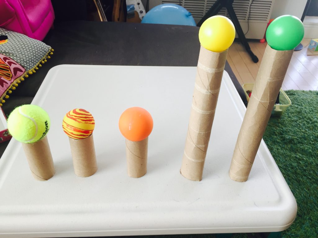 Balancing balls on paper tubes, 25+ activities for toddlers, activities for 18-24 month old, activities for 18 month old, activities for 19 month old, activities for 20 month old, activities for 21 month old, activities for 22 month old, activities for 23 month old, activities for 24 month old, activities for two year old, activities for three year old, learning activities for toddlers